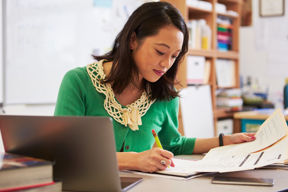 woman with papers and laptop